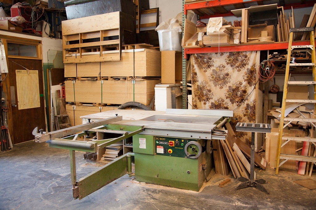 a woodworking shop with a cabinet table saw