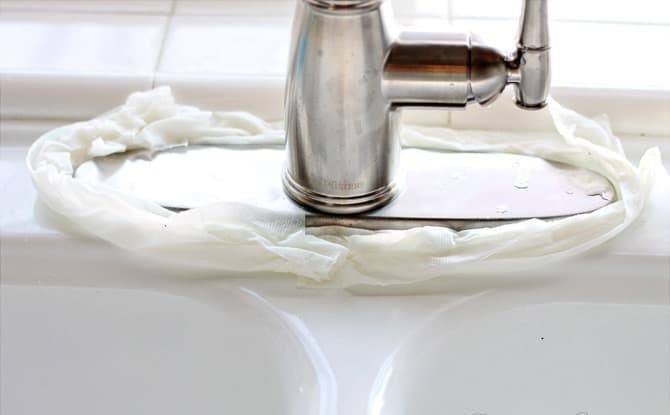 Paper towels dampened in vinegar placed around the sink faucet